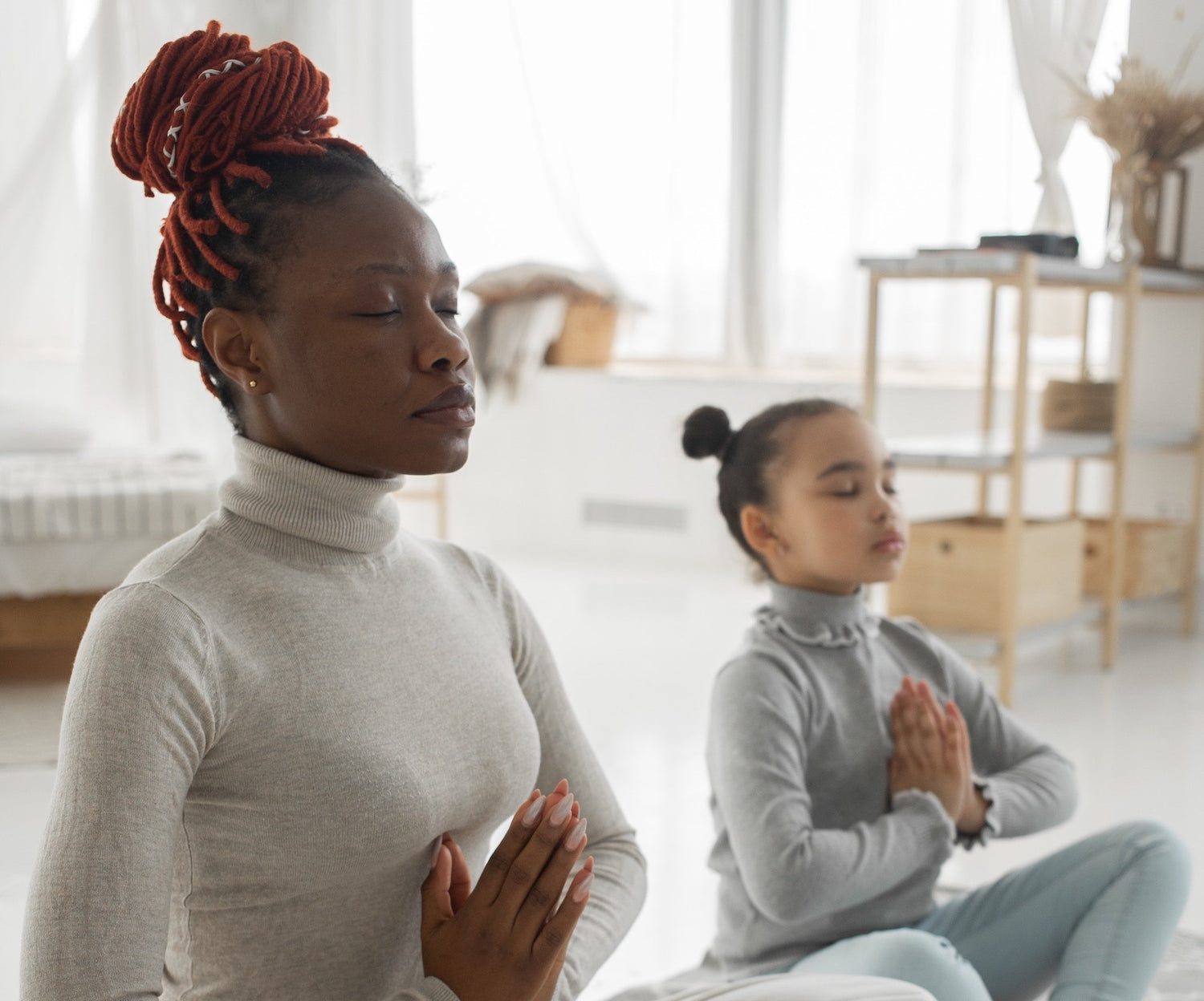 woman and daughter doing yoga